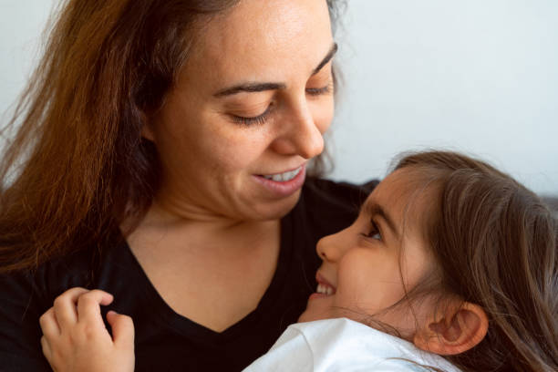 istock Mother and daughter hugging and looking at each other lovingly 1314380336