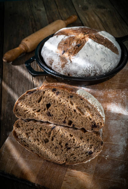 istock Sourdough bread loaf homemade with cast iron pan texture crumb on rustic wood 1314381240