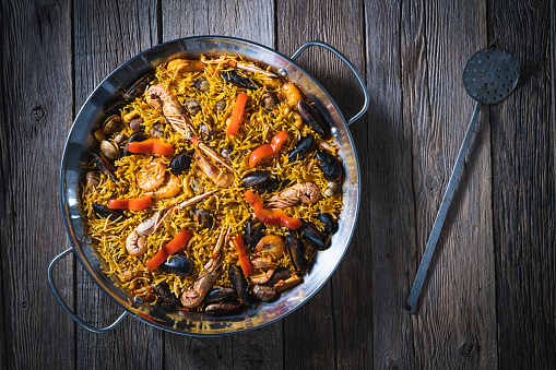 Seafood paella fidegua fideua recipe from Spain in a paellera made with noodles instead rice, with shrimp, crawfish, clams and mussels, spanish food.