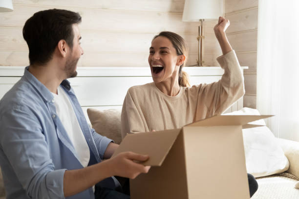 istock Excited couple triumph unboxing package shopping online 1314381701