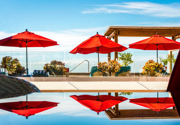 Holiday image - refelctions of the vibrant umbrellas against a bright sunny blue sky. background