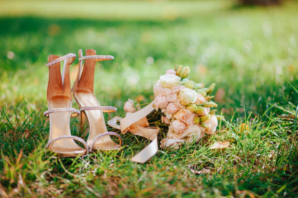 istock Artificial flowers side by side with a pair of women's sandals 1314382438