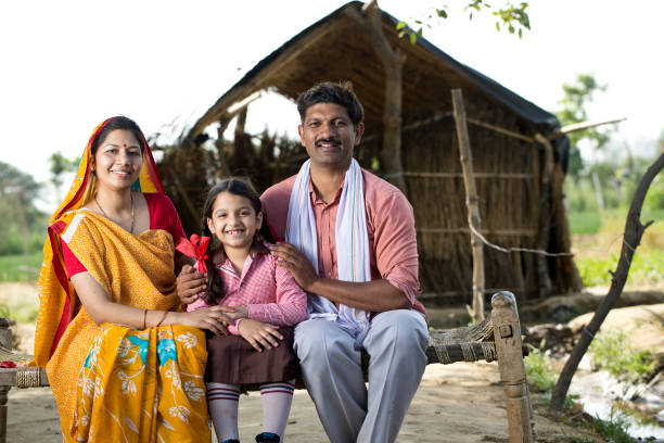 istock Indian family sitting on traditional bed 1314382820