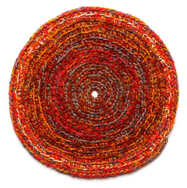 istock Round mat of brown color crocheted from thick threads. Isolated on a white background 1314382999