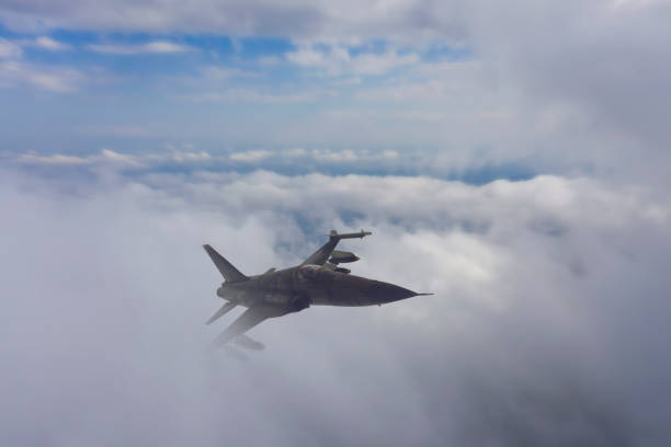 istock F-5E Tiger II jet airplane flying over the clouds. 1314383058