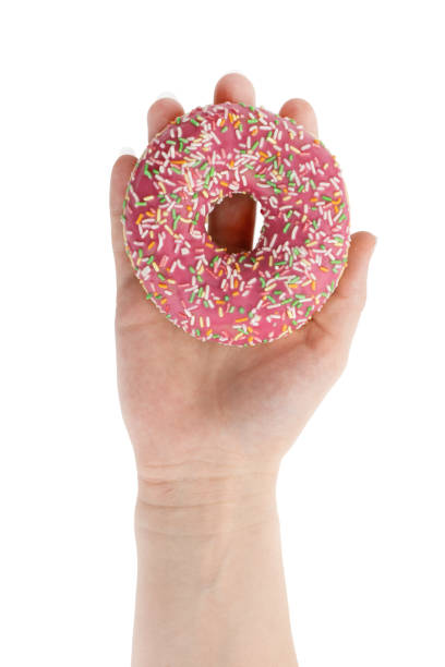 istock Donut close-up in hand on a white background. Round donut isolated on white background. 1314384367