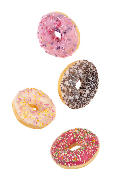 istock Donuts close-up on a white background. Flying round donuts isolated on white background. 1314384700