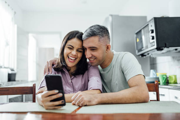 istock Smiling couple on online shopping in the kitchen 1314385509