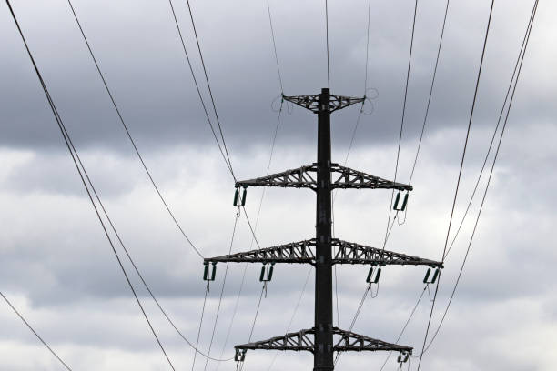 istock High voltage tower silhouette with electrical wires on storm sky background with dark clouds 1314386839