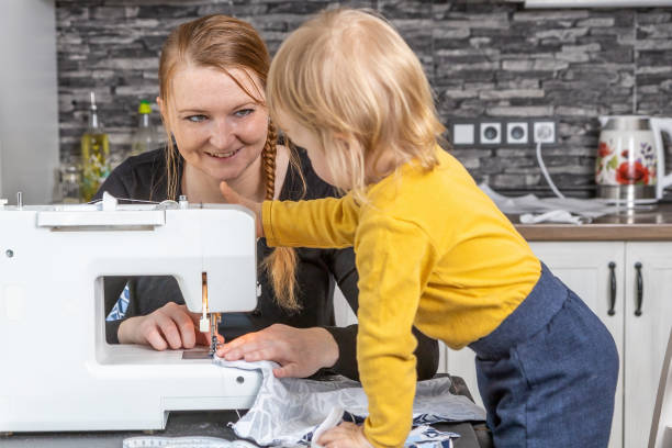 istock Smiling young mother is sewing with her son together. 1314388185