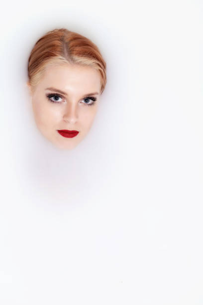 istock Attractive young woman lying in spa bath with milk. Vertically. 1314388193