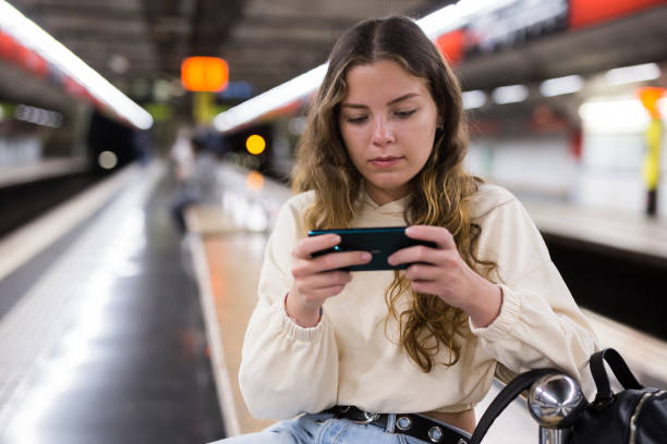 istock Young attractive girl in jeans waiting for subway train on a platform 1314389552