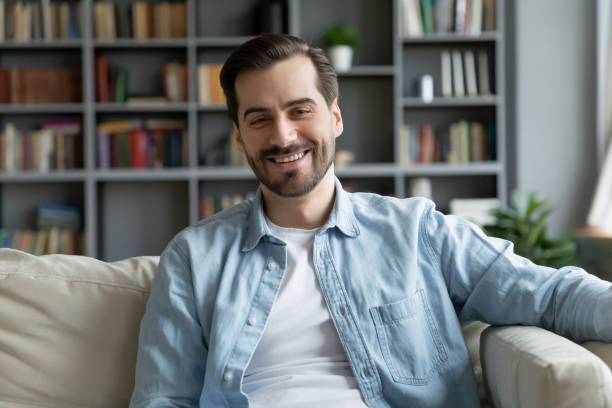 istock Portrait of happy young handsome man, relaxing on comfortable sofa. 1314393157