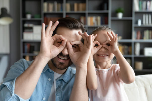 istock Happy young father making binoculars with fingers with daughter. 1314393206