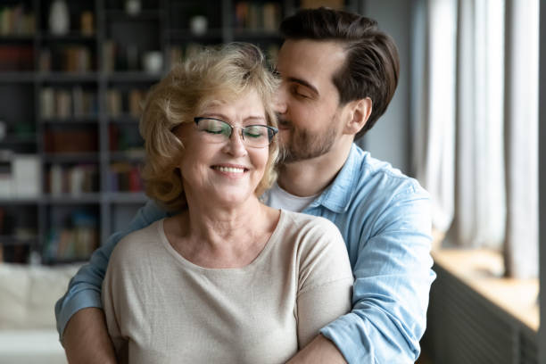 istock Devoted young man showing care to smiling retired old mother. 1314393305