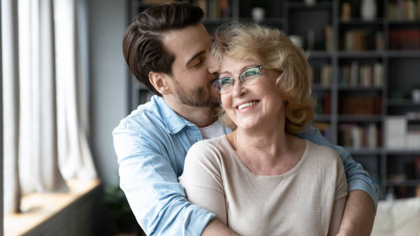 istock Affectionate grown son feeling appreciation to mature elderly mother. 1314393307