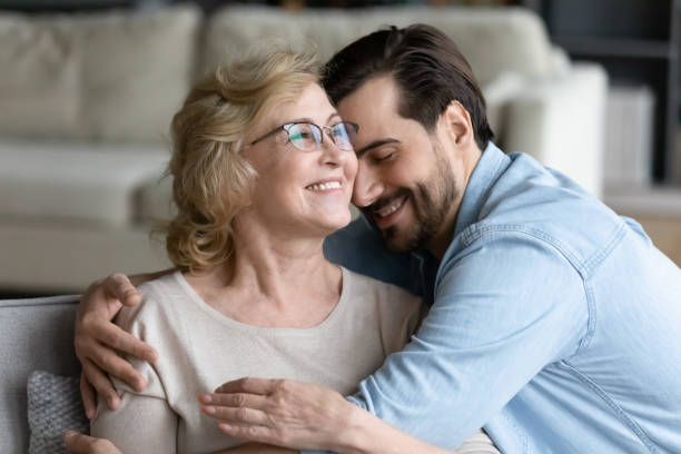 istock Young caring son cuddling happy elderly senior retired mother. 1314393323