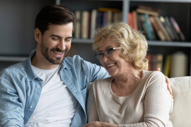 istock Happy young man enjoying funny conversation or gossiping with mum. 1314393345