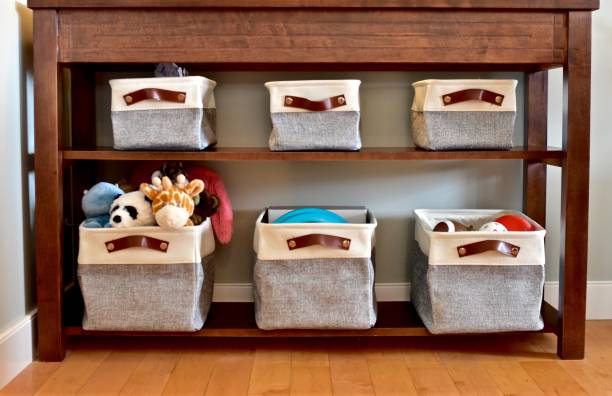 Easy storage solution drawers and basket bins on book shelf Home organization solutions of drawers and baskets in baby toddler rooms and living rooms for easy kid toy clean up and storage arranging stock pictures, royalty-free photos & images