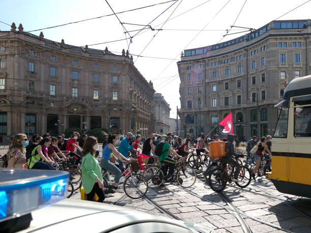 Milan, Italy - October 2, 2011: Women cycling on the bicycle lane on a street of Milan.