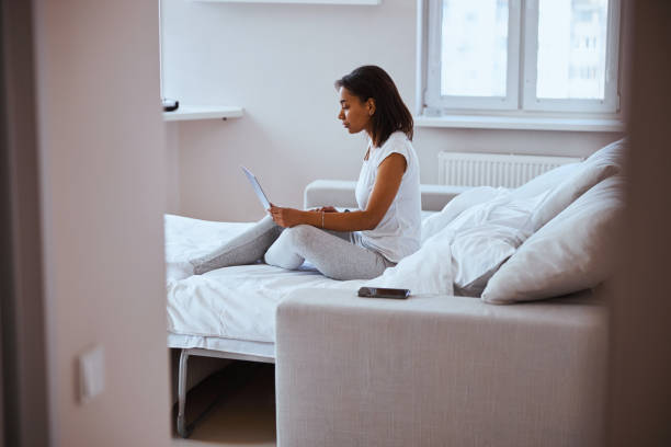 istock Charming young woman using notebook in bedroom 1314394794