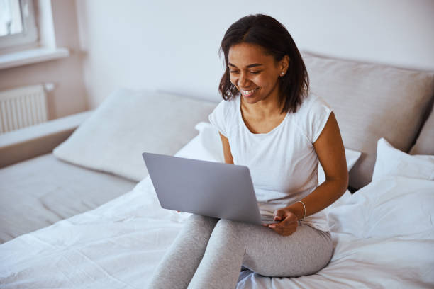 istock Joyful young woman using modern laptop at home 1314394839