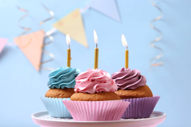 istock Delicious cupcake with a candle on a colored background with space for text. 1314394989