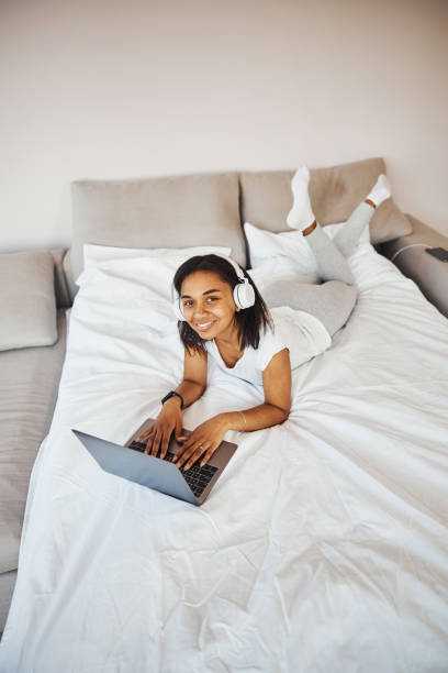 istock Attractive young woman in headphones using notebook at home 1314395072