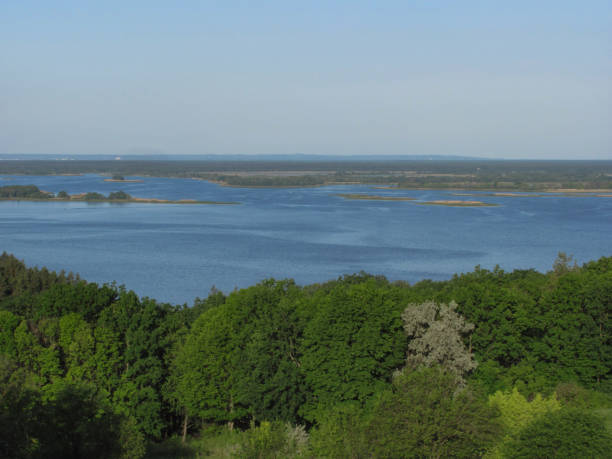 istock landscape background: green forest, river with islands and blue sky 1314399507