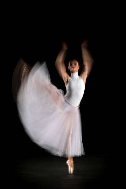 istock Ballerina is dancing black background 1314399699