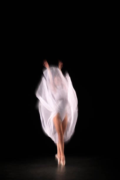 istock Ballerina is dancing black background 1314399700