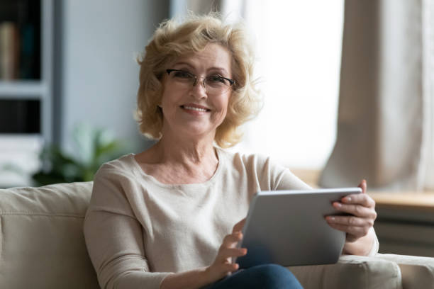 istock Portrait of beautiful smiling elderly woman using digital tablet. 1314402180