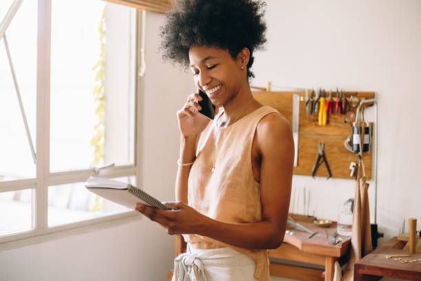 istock Happy jeweler on phone in studio 1314402776