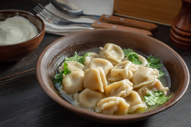 Russian meat dumplings with sour cream Meat dumplings with sour cream. Pelmeni russian national dish russian pelmeni stock pictures, royalty-free photos & images