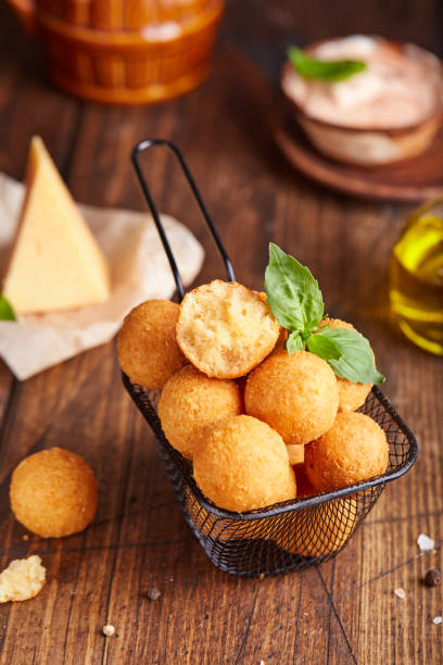 istock Deep fried Cheese balls. Freshly baked croquettes, served with basil leafs and sauce. 1314405471