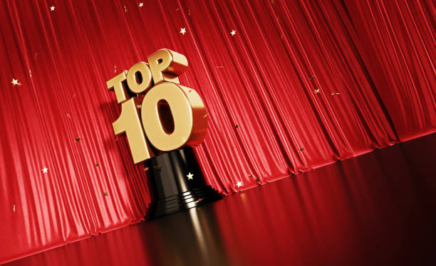 Top 10 Concept - Gold Colored Confetti Falling Onto A Gold Top 10 Award Sitting Before Red Stage Curtain Gold colored confetti falling onto a gold top 10 award sitting before red stage curtain. Horizontal composition with copy space. Low angle view. Top 10 concept. armed forces rank photos stock pictures, royalty-free photos & images