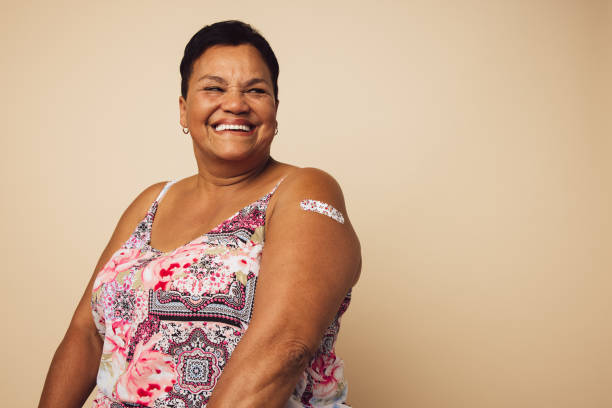 Senior woman smiling after getting vaccination