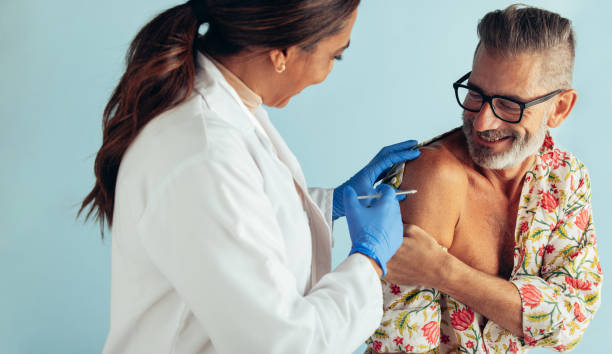 istock Smiling man getting vaccine from a doctor 1314406515