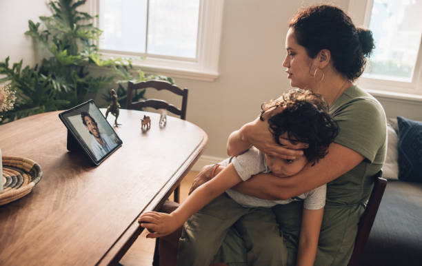 istock Mother with her sick son video calling online doctor 1314406622