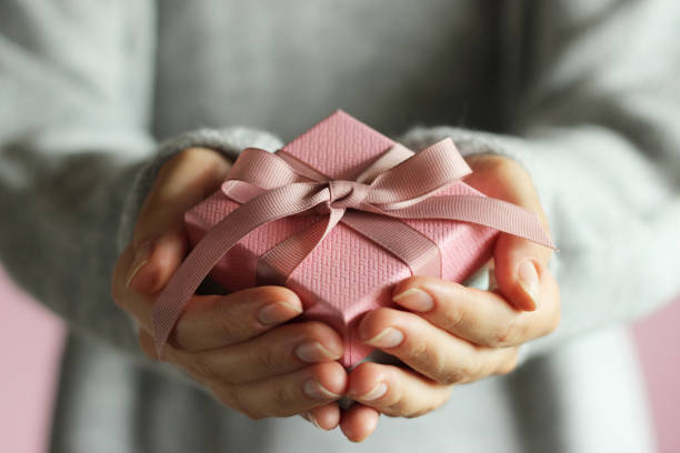 istock gift box in female hands. Holiday, give, gift. 1314407463