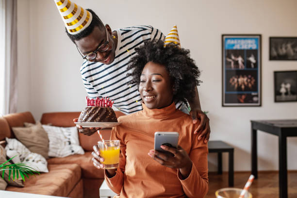 istock Young man surprising his girlfriend with a cake on her birthday 1314407510