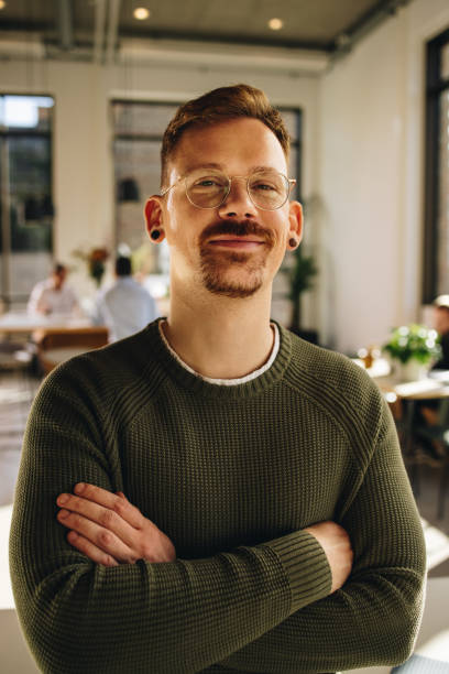istock Happy manager looking at camera and standing in office space 1314407858