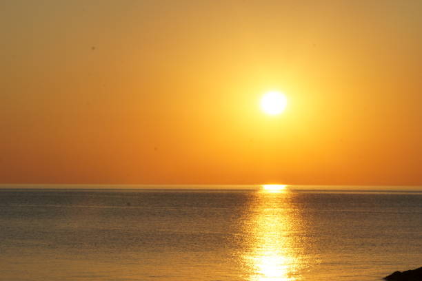 istock Sunrise over the calm sea 1314408677