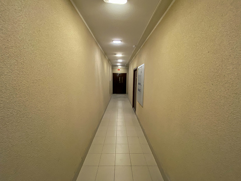 Long Corridor With Metal Doors, Tilled Wall And Floor.