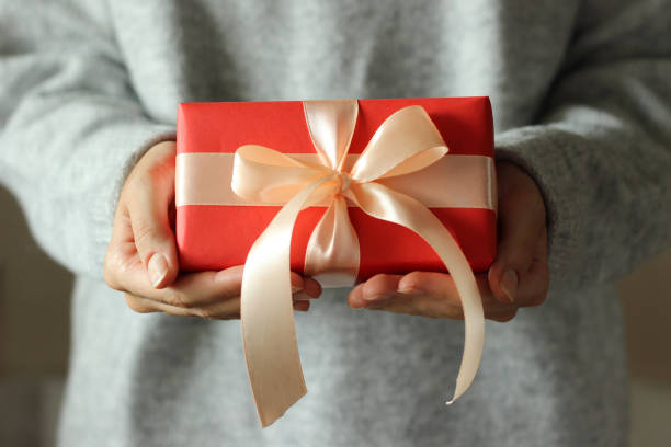 istock gift box in female hands. Holiday, give, gift. 1314409585