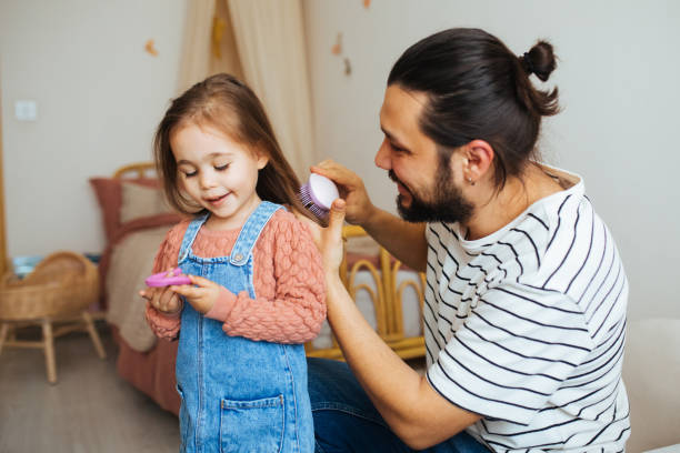istock Responsible good father combing little daughters hair, preparations for school 1314409625