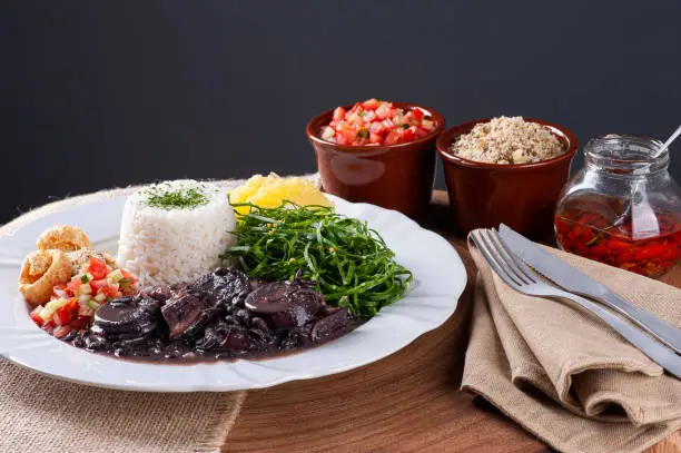 Typical dish of Brazilian cuisine called Feijoada, with black beans, bacon, sausage and pork