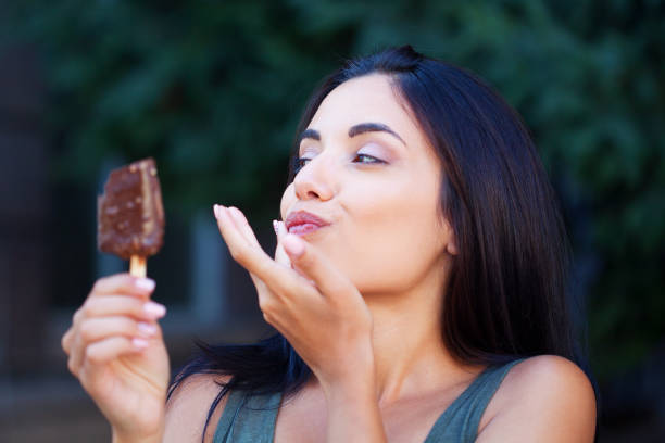 istock Beautiful woman eating ice-cream 1314411977