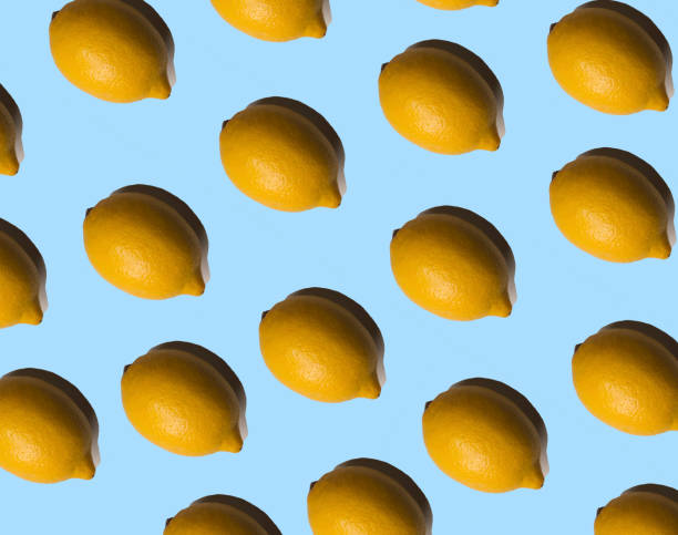 istock Multiplied lemons with shadows on pastel blue background 1314412055