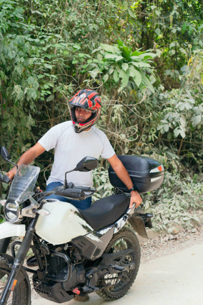 istock Man next to his motorcycle on a rural road 1314412437